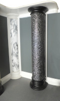 Half column covered in sparkly film with black foot and head